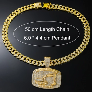 Detailed view of iced-out gold excavator pendant with size specs on black background