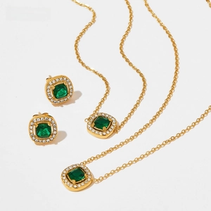 Detailed macro view of French court style emerald cut green gems in gold settings