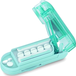 Mint green portable pill cutter with stainless steel blade and multi-slot V-shaped holder