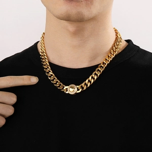 Close-up of 11mm gold Cuban chain necklace with iced out round clasp on a model
