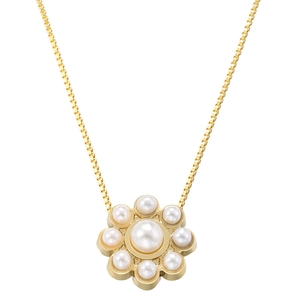 Detailed close-up of a golden flower pendant necklace with white pearls on a box chain