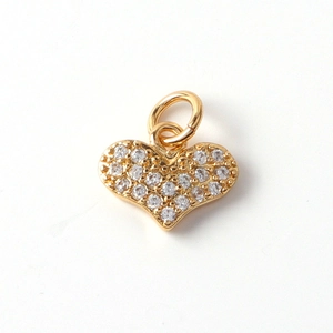 Detailed close-up of gold-plated heart pendant with micro-paved cubic zirconia stones