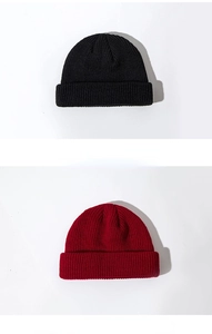 Detail showing the fine knit texture of black and burgundy short beanie skull caps