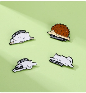 Detail of four cute alloy animal pins featuring sheep, hedgehog and cat with funny quotes