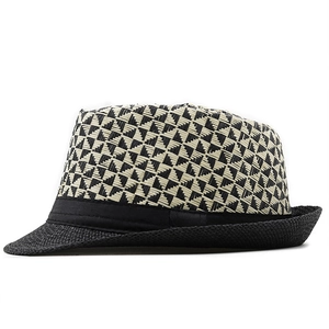 Close-up of geometric woven pattern on summer fedora hat with black decorative ribbon