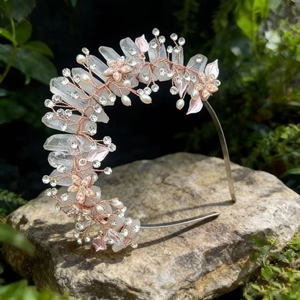 Detail of handmade crown headband with pink crystals, pearls and rhinestones on stone