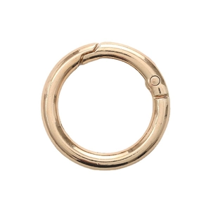 Golden zinc alloy spring ring buckle for bags and keychains on white background