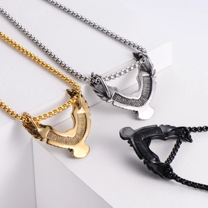 Detail of eagle pendants in gold silver and black with stainless steel bead chains
