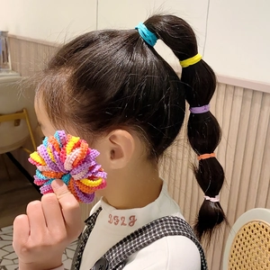 Detail showing elastic floral hair ties and small candy colored bands for girls' hairstyles