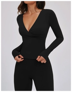 Detail of black V-neck wrap yoga top showing the high-elastic fabric and sleek fit