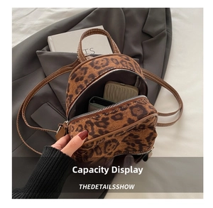 Detail view of mini leopard print backpack showing interior storage capacity and main pocket