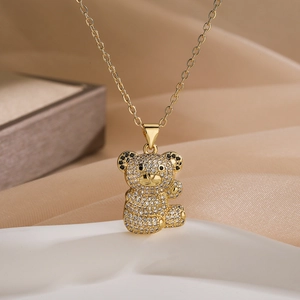 Gold-plated bear pendant necklace with sparkling white and black zircon crystals