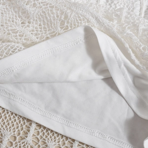 Detail of white mesh lace dress showing breathable diamond mesh and fine stitching