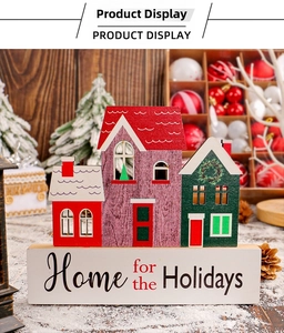 Close-up of hand-painted wooden Christmas house ornaments on a holiday themed base