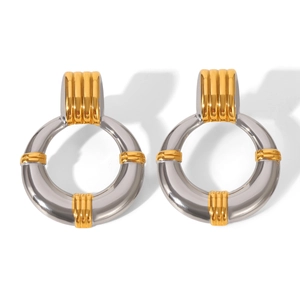 Detail of chunky two-tone gold and silver hoop earrings with high-polish metallic finish