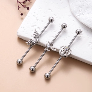 Three silver stainless steel industrial barbell earrings with wings, bee, and moon charms