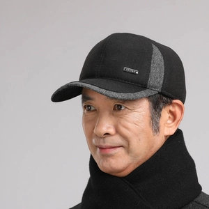 Detail of winter baseball cap for elderly men with warm ear flaps and sport metal tag