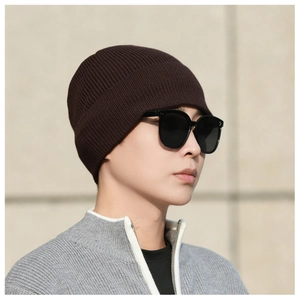 Close-up of chocolate brown knit beanie with detailed ribbed texture for winter warmth