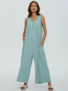 Detail of mint green ribbed knit sleeveless jumpsuit with buttons and side pockets