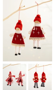 Detailed view of handmade Christmas cloth doll ornaments with intricate knitting and lace