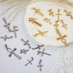 Variety of gold and silver stainless steel cross pendants on decorative lace