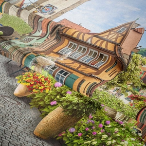 Detailed close-up of scenic European town tapestry featuring floral decor and stonework