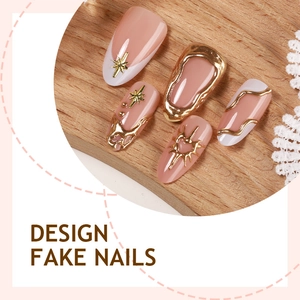 Nude pink almond fake nails with gold stars, heart charms and white French tip designs
