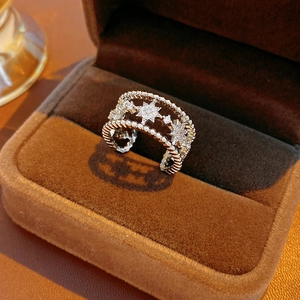 Detailed macro view of silver multi-layer hollow star ring with cubic zirconia in a jewelry box