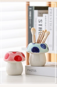 Close-up of cute mushroom-shaped ceramic brush holders for desk organization and decor