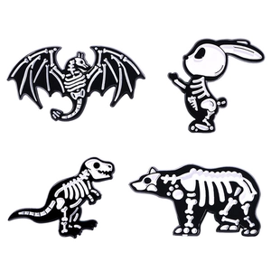 Set of four skeleton animal enamel pins including bat, rabbit, dinosaur, and bear