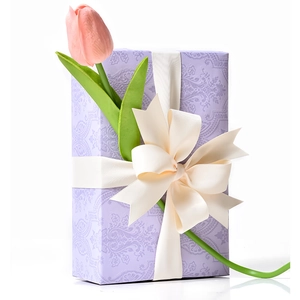 Elegant purple embossed gift box with cream ribbon bow and pink tulip decoration