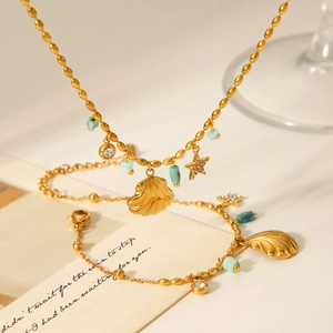 Detailed shot of golden shell and star pendant necklace with turquoise stone accents