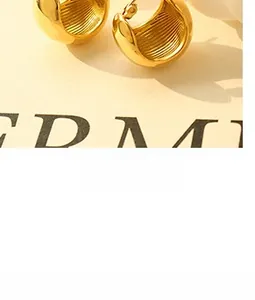 Detailed view of gold plated semi-hoop earring featuring vertical ribbed inner texture