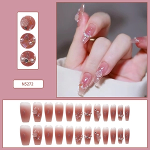 Detail of pink gradient coffin press-on nails with 3D white flowers and pearls