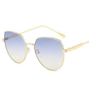Golden metal cat eye sunglasses with blue yellow gradient lenses and large frames