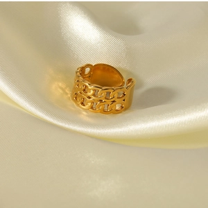 Macro view of double-layer hollow chain ring on elegant silk fabric background