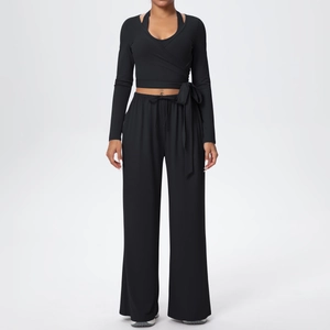Détail du haut de yoga noir à manches longues et pantalon large à taille haute