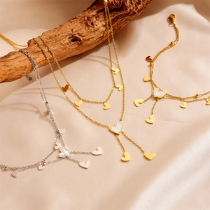 Golden heart necklace and bracelet set with mother of pearl inlays on silk