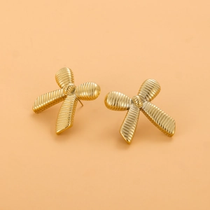 Gros plan détaillé des boucles d'oreilles nœud dorées avec une texture métallique raffinée