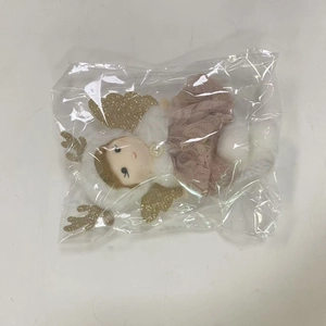 Pink plush angel doll with golden wings and lace dress in protective packaging