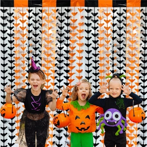 Halloween party background curtain featuring orange and black bat tassel decorations