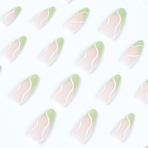 Green French tip almond press-on nails with white wave patterns and a glossy finish
