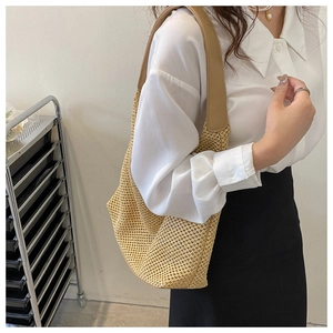 Detail of khaki woven shoulder bag featuring hollow texture and premium brown PU strap