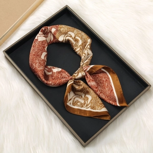 Satin silk square scarf with vintage rose paisley print on black tray and fur background