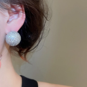 Close-up of a large silver S925 stud earring featuring sparkling round pavé zircon stones