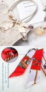 Detail of red and white silk scarf with gold chain pattern on handbag handle