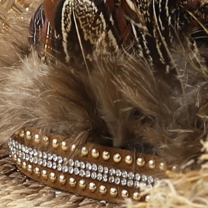 Detail of western raffia cowboy hat with feathers, suede band, and sparkling rhinestones