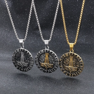 Three Viking Mjolnir necklaces in silver and gold finishes with Runic circle engravings