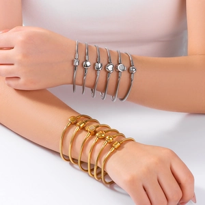 18K gold and silver snake bone chain bracelets with various shaped clasps worn by model