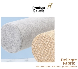 Detailed view of soft gray velvet and natural linen fabrics for jewelry display stands